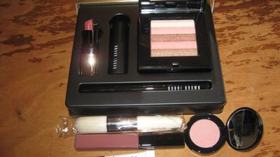 Freebies!  Instant Glam Set which includes a mini Luxe Lip Color in Neutral Rose, a mini Eye Opening Mascara, Shimmer Brick in Sunset Pink; Blackest Black Ink liner; brush; lip gloss in Nude; and a mini Illuminating Bronzing Powder in Antigua