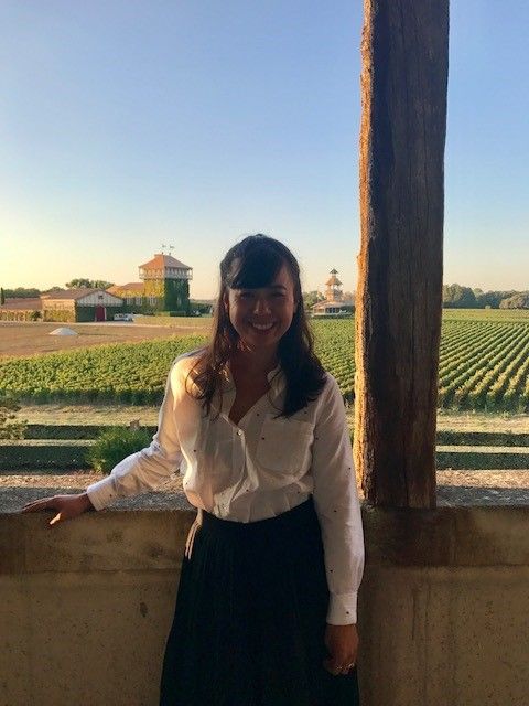 Picture of me in front of Chateau Smith Haut Lafitte - those fields in the front are the white grapes used for Caudalie skincare!