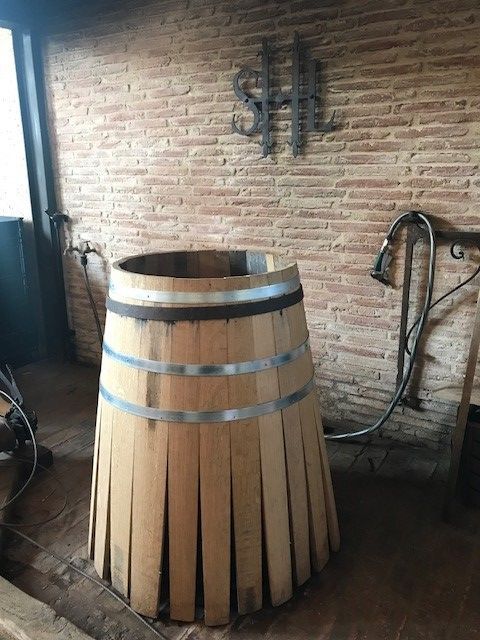 Here is a pic of the wine barrel being built. They need to use fresh wood to make sure the wine flavor isn't altered unexpectedly and have to match up boards perfectly like a puzzle to get a snug barrel.