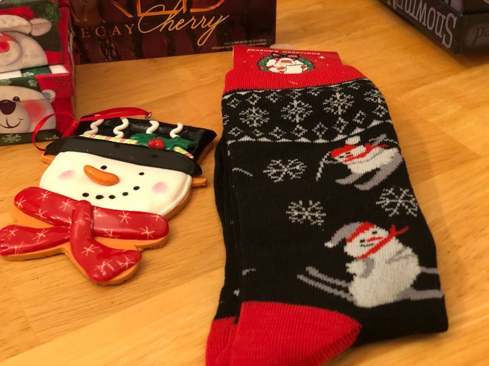 I also received this unbelievably adorable snowman ornament, and Christmas snowman socks (I love snowmen!). The ornament is already on my tree, and I'm wearing my new socks today!