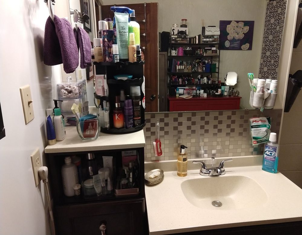 Most of my hair/body/skincare resides on the carousel, except daily cleansers to the left of it. Cotton and qtips in the little tower in the very back. The glass jar holds some sample packets I want to work into rotation as I use other stuff up.