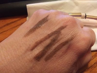 Far left swatch is the gel; the others are the pencil. Looks like a warm brown to me here, and on my eyes.