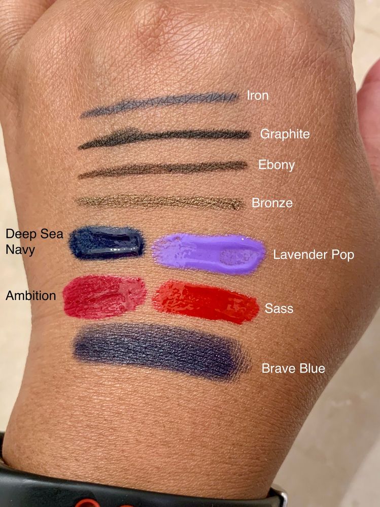 Swatches in warm bathroom lighting of Catrice, UOMA, and MUFE products.