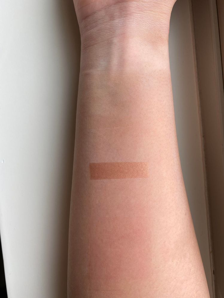 This is the Westman Atelier Super Loaded Tinted Cream Highlighter in Peau de Soleil swatched on my arm.