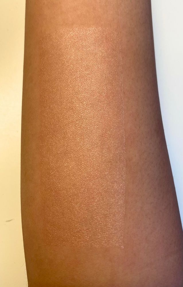 This is the Saie Glowy Super Gel Lightweight Dewy Highlighter in Starglow swatched on my arm.